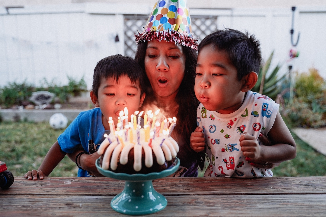 mother and son blowing out birthday candles